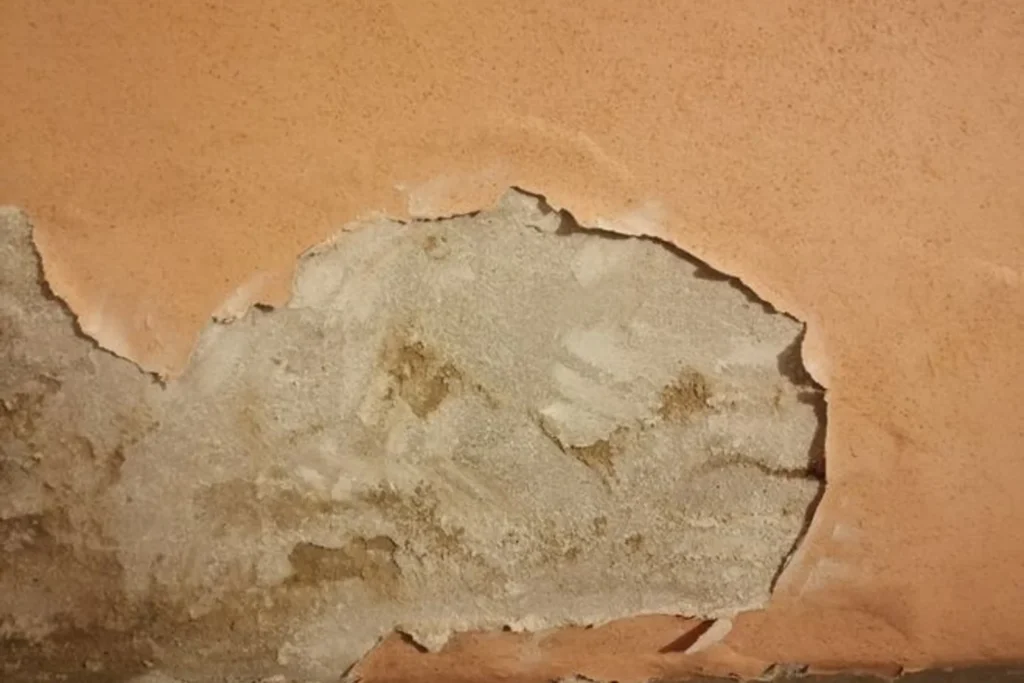 Patch of parging broken away from a basement wall